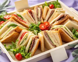 Mixed sandwich platter with labelled fillings arranged on a delivery tray